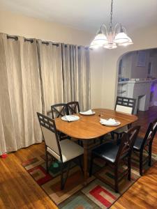 a dining room with a wooden table and chairs at Gorgeous 3 BR Lower Unit Home in Buffalo +26 photos