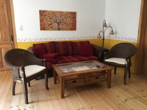 a living room with a couch and two chairs at Villa Wieck am See, mit Ruderboot in Gransee