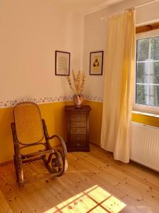 a room with a rocking chair and a window at Villa Wieck am See, mit Ruderboot in Gransee +28 photos