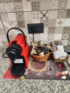 a red mower sitting on a counter with a basket at Casa Don Paolo e Donna Caterina in Bagheria +64 photos