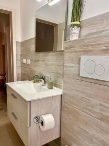 a bathroom with a sink and a mirror at House on the beach in Lido Marini +13 photos