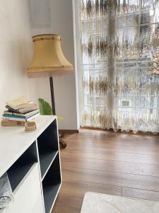 a living room with a lamp and a window at A&A Apartments Prizren in Prizren +33 photos