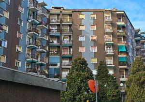 a tall building with balconies and trees in front of it at Casa Alice in Milano Parco Nord in Bresso