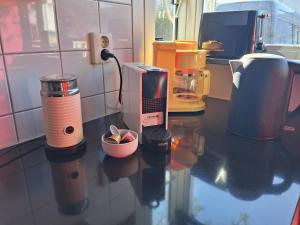 a counter in a kitchen with a coffee maker at House nearby Amsterdam in Almere