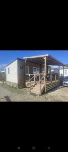 a small house with a porch and a shed at Mobile-home tout confort 6 personnes climatisé in Sète