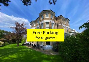 a building with a sign that reads free parking for all guests at Applewood Hotel in Bournemouth