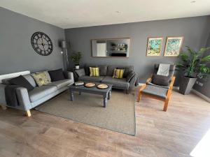 a living room with a couch and a table at Old Orchard in Saundersfoot