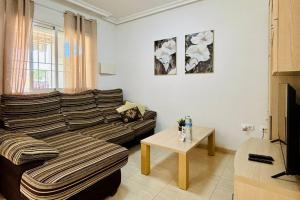 a living room with a couch and a table at Casa Abuelo Fico by Rental Hero in Los Alcázares