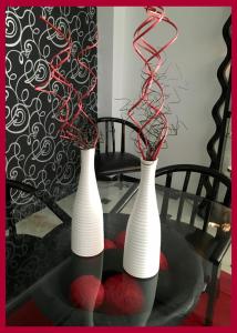 two white vases sitting on top of a glass table at Hotel Albatros in Gandía