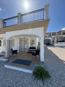 a patio of a house with chairs and a staircase at Budoni residence Lutturai 4 in Budoni