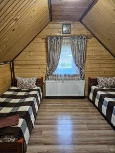 Postel nebo postele na pokoji v ubytování Ластівчине гніздо