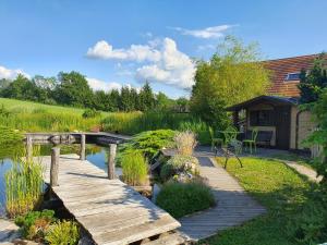 a wooden bridge over a pond in a garden at Lacustrebnb in Choisy