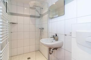 a bathroom with a sink and a shower at Diekhus SPO Diekhus 3 in Böhl +37 photos