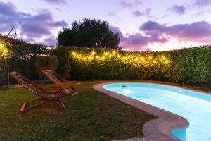 a couple of chairs sitting next to a swimming pool at Pantin Beach View Villa Pool Aloha-te in Pantín