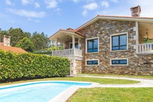 a stone house with a swimming pool in front of it at Pantin Beach View Villa Pool Aloha-te in Pantín