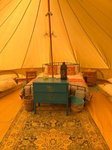 a bedroom with a bed in a tent at Swallows Oast Glamping in Sedlescombe