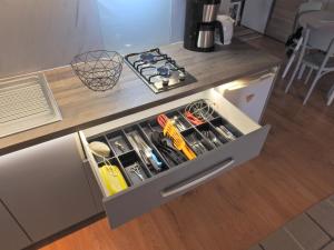 a drawer in a kitchen with tools in it at Apartman Lastovicka , stay with mountain view ,free parking and few steps to the shop in Stará Lesná