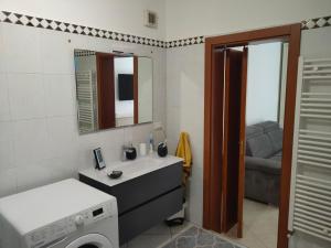a bathroom with a sink and a washing machine at Casa Giuseppe in Taranto