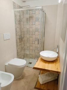 a bathroom with a toilet and a sink and a shower at Pascasio17 in Mola di Bari +13 photos