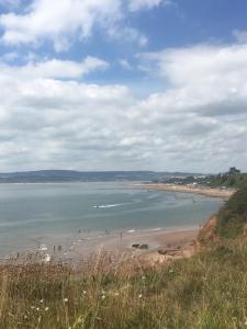 a beach with people on the sand and the water at Number 28a in Exmouth