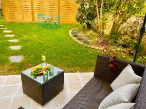 a patio with a table with a bottle of wine at Gîte de Dampierre in Dampierre +9 photos