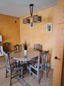 a dining room table with chairs and a table and a table and chairs at Casa Buenavista in Las Navas del Marqués +7 photos