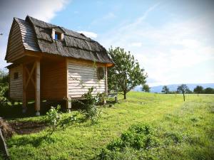 an old house with a roof on a field at Gîtes du vrai monde in Fillinges