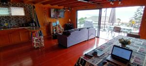 a living room with a couch and a table at Casa Surf Tongoy in Tongoy