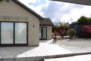 a house with a large sliding glass door at Luxury 2 bedroom property in quiet location close to SW Coastal Path in Paignton