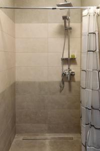 a bathroom with a shower with a shower curtain at Milla Apartman Szeged in Szeged +15 photos