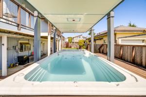 an indoor swimming pool in the backyard of a house at Walk to Poplar Beach Cozy Coastal Getaway with Yard in Half Moon Bay
