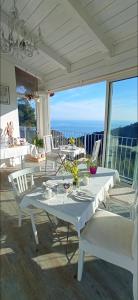 a white table and chairs on a patio at Message in a Bottle Bed and Breakfast in Camporosso