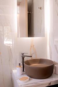 a bathroom sink with a large brown bowl at Luxury apartment Reverie in Sfakia +10 photos