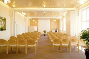 a room with a row of chairs and a podium at Haus Schwarzwaldsonne in Freudenstadt