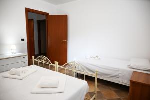 a bedroom with two beds and a mirror at Casa Stella Marina by Bianco Puglia Vacanze in Specchiolla 
