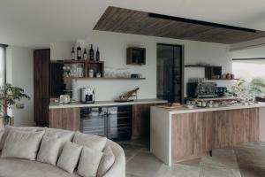 a living room with a couch and a kitchen at Au Porte Bonheur in Zwalm