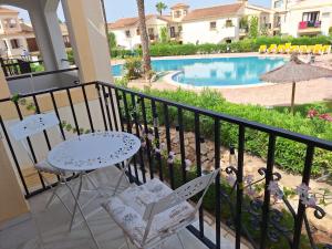 a balcony with a table and chairs and a swimming pool at Vera Coast family days in Vera