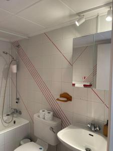 a bathroom with a toilet and a sink and a mirror at Limnaria Westpark 2 bdrm apartment 122 in Paphos +26 photos