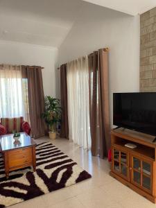 a living room with a large flat screen tv at Limnaria Westpark 2 bdrm apartment 122 in Paphos