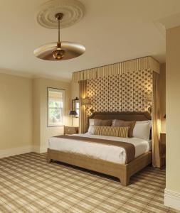 a bedroom with a large bed and a ceiling at The Asticou Hotel in Asticou
