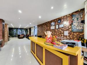 a lobby with a yellow counter in a building at Kundan Hotel and Restaurant in Manāli