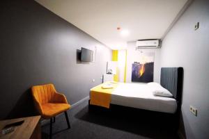 a small room with a bed and a chair at Polo Suit Otel in Avcılar