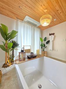 a large white bath tub in a room with a ceiling at La Solis in Incheon +26 photos