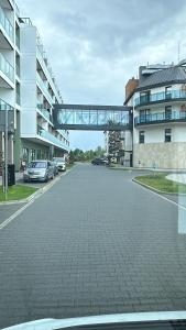 an empty street with cars parked in a parking lot at Sunny Haven Bel Mare Parking, Basen FREE in Międzyzdroje