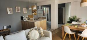 a kitchen and a living room with a table and chairs at Lively Sopela House by Kima Gestíon in Sopelana