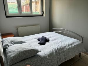 a bed with a stuffed animal on top of it at Cozy apartment in Caudry