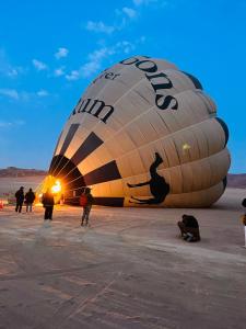 a large hot air balloon in the desert at Desert Elegance Luxury Bedouin Camp Panoramic View in Disah