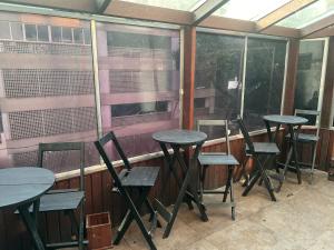 a row of tables and chairs on a balcony at Castle of Vibes - Hostel in Rio de Janeiro