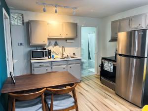 a kitchen with a table and a stainless steel refrigerator at The True The Archive Lofts in Marion