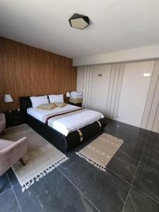 a bedroom with a large bed with white sheets at Penthouse - 1st Line To The Sea in Bat Yam